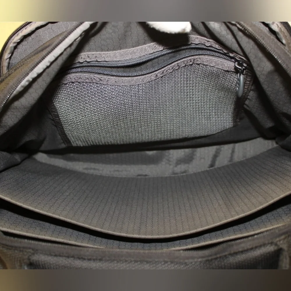 TUMI Black Backpack with Padded Straps and Multiple Compartments